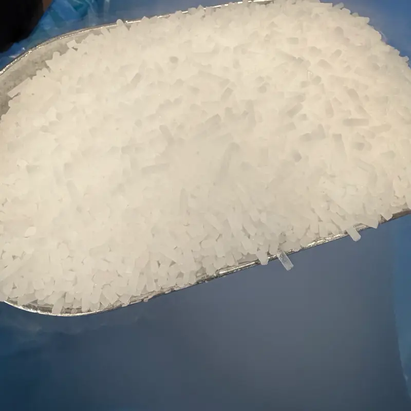 A metal scoop heaped with dry ice pellets
